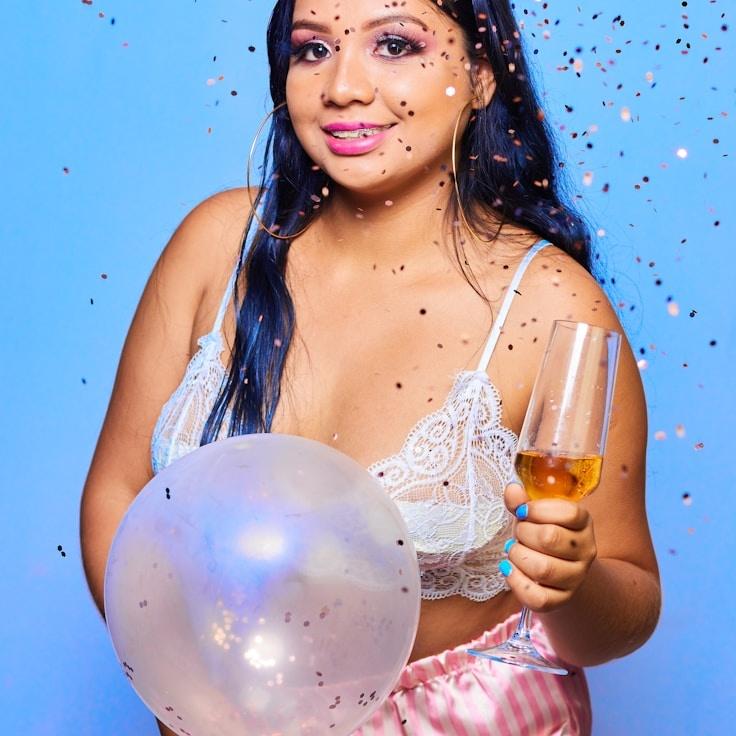 Aisha Kapoor, Lead Design Curator at Quay Moss Studio, reviewing corporate floral arrangements